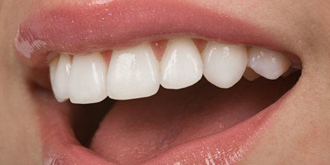 Close up of woman smiling.