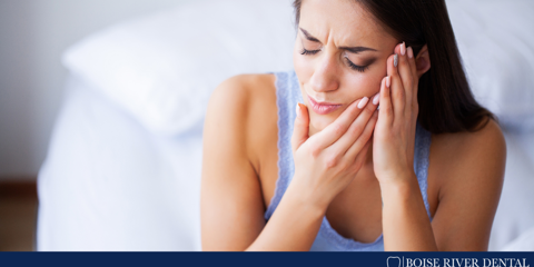 woman holding side of face