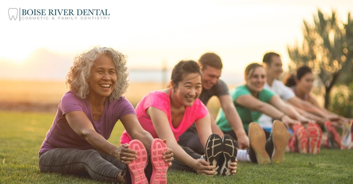Group of adults stretching outside
