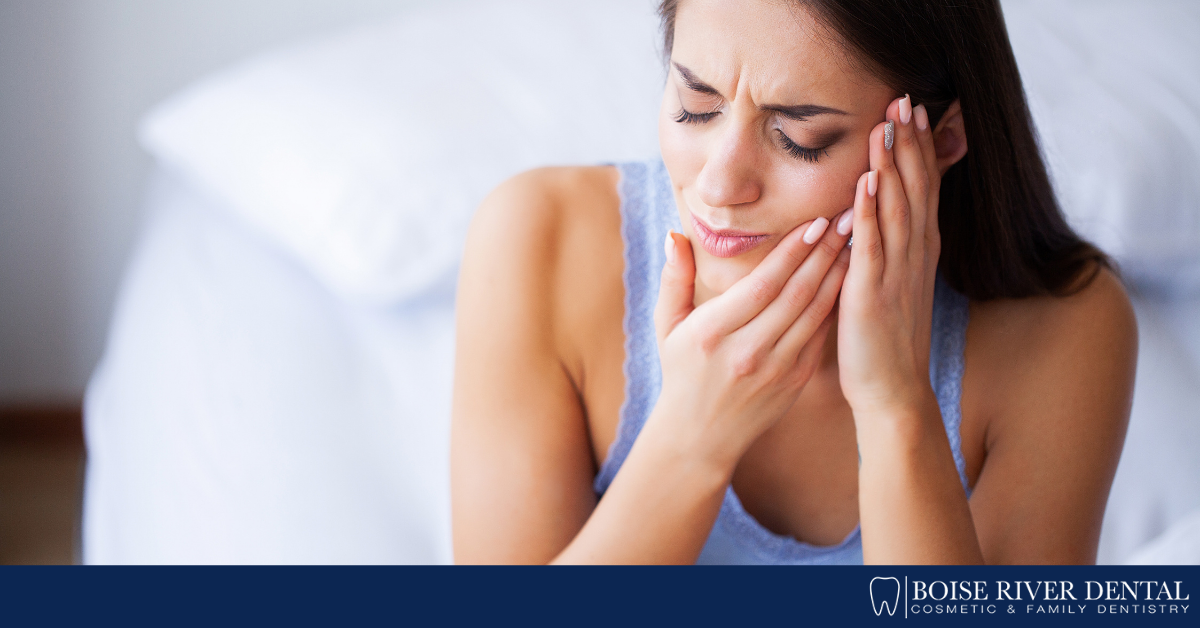 woman holding side of face